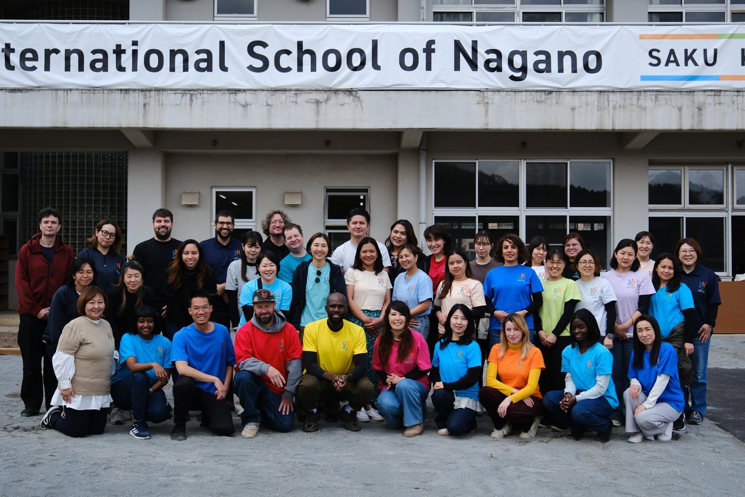 Staff from every ISN campus gathered in front of the Saku Kirihara school building